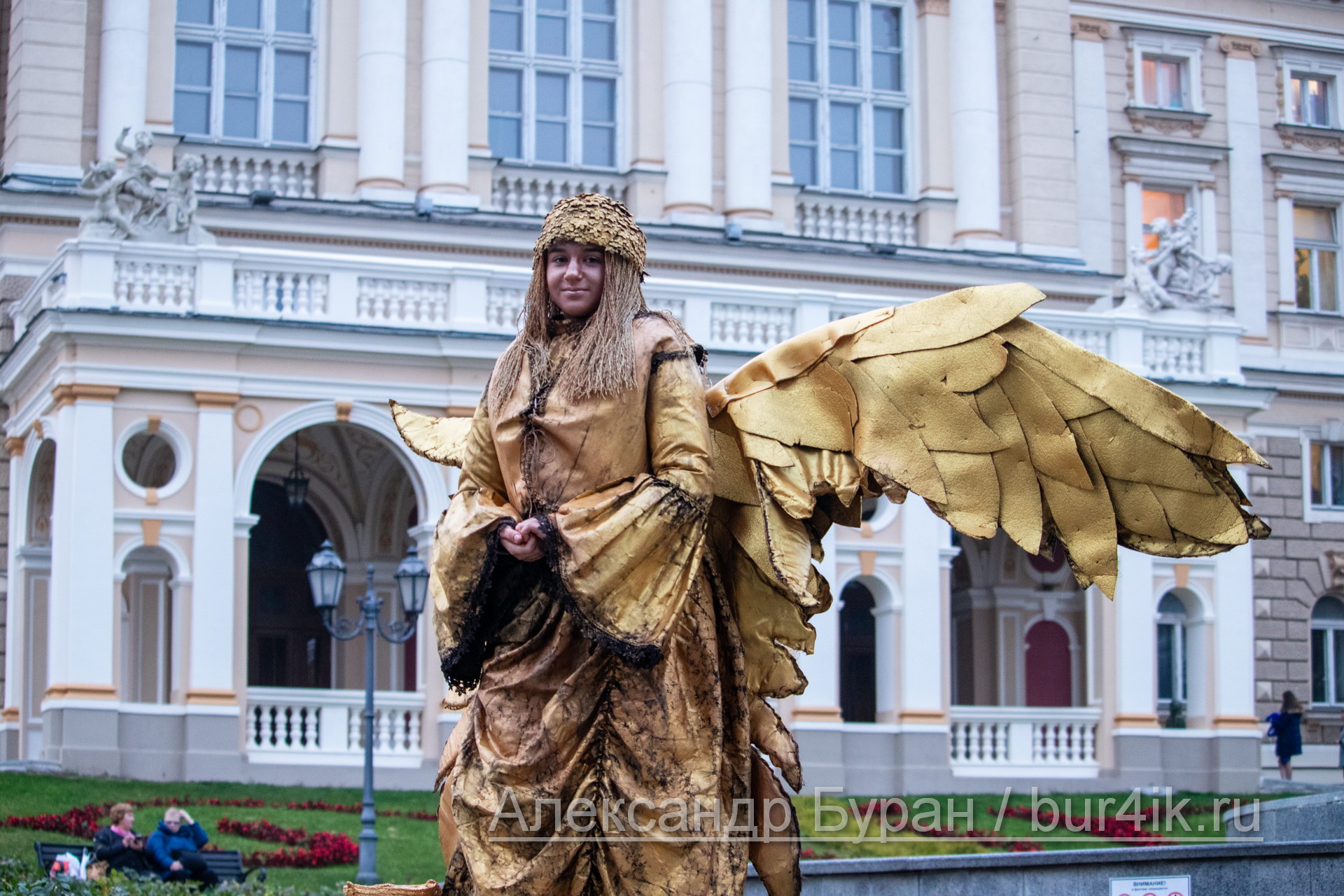 Молодая девушка в золотом костюме ангела предлагает с ней сфотографироваться за деньги - Украина, Одесса, 09,11,2019