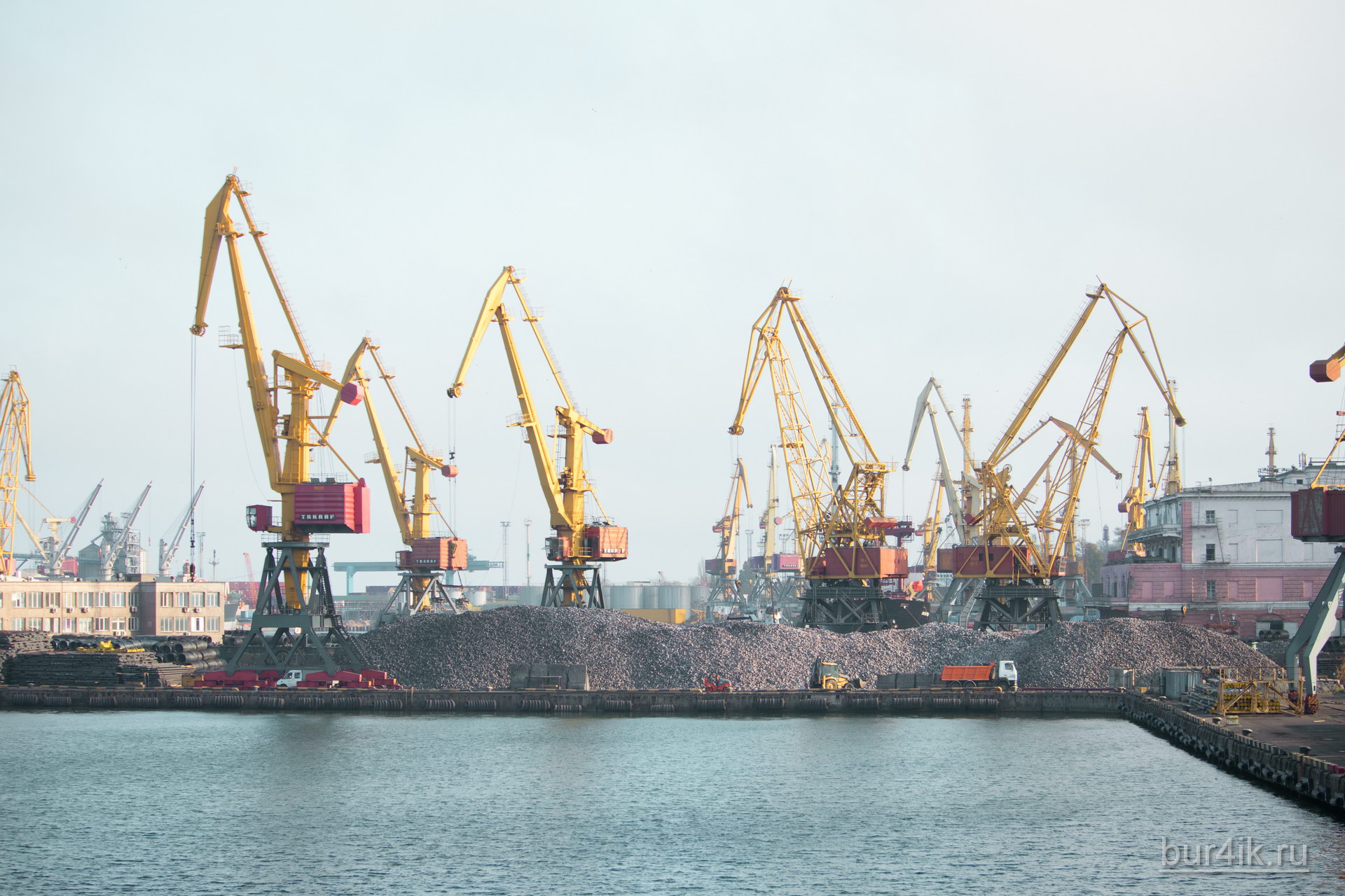 Покрашенные желтой краской краны в порту у моря в городе Одесса 39