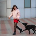 Girl in a red skirt with a black dog - Ukraine, Odessa, 11,06,2020