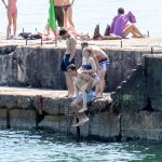 Подростки прыгают в воду на море