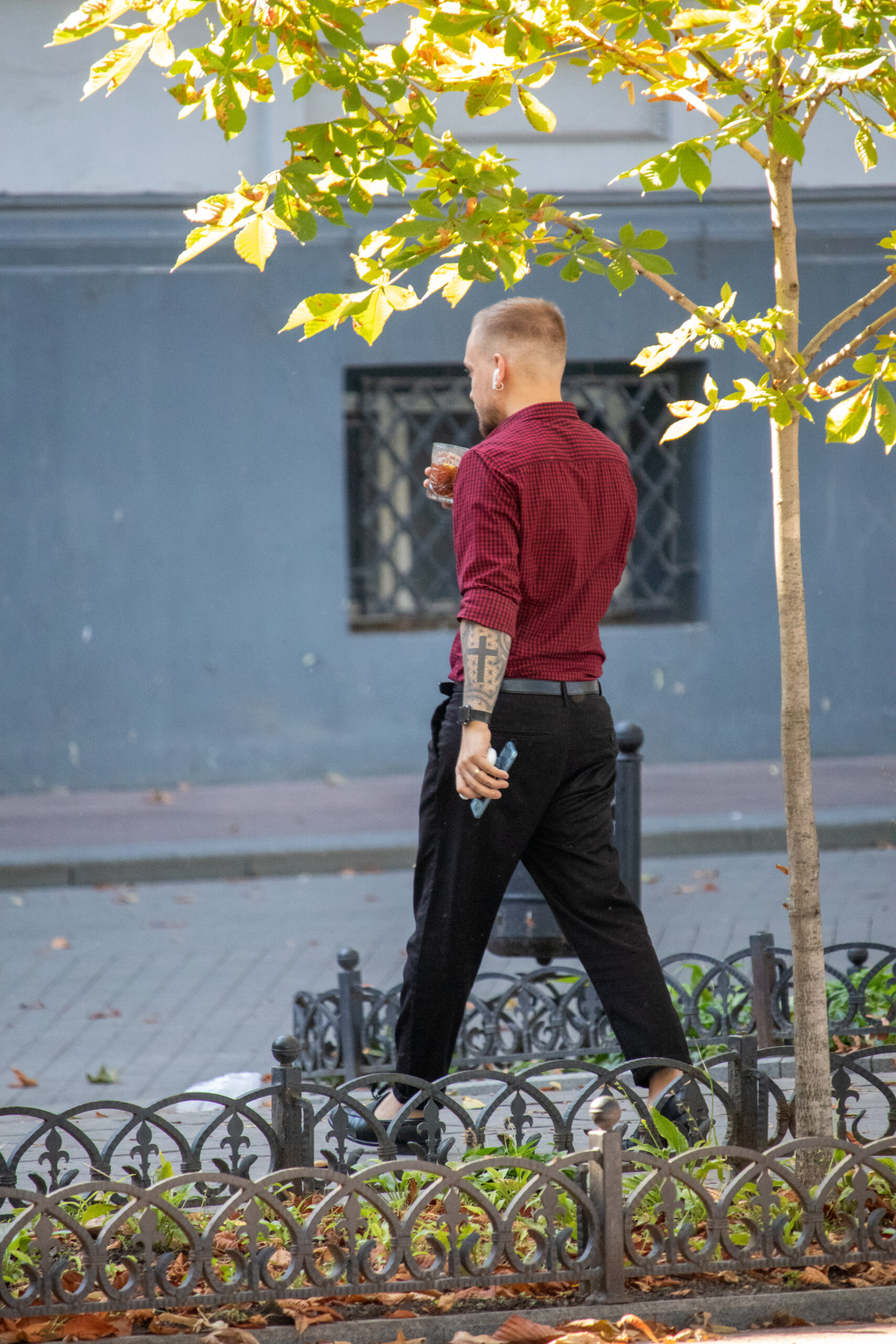 Man with cross tattoo and alcohol on the street - Ukraine, Odessa, 27.09,2020